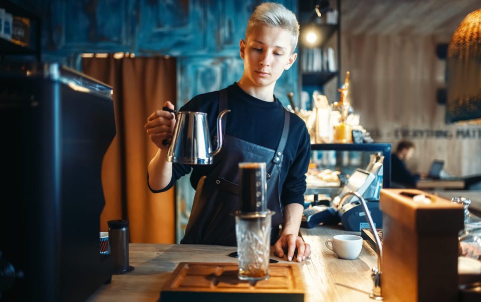 Barista Pours Water From Coffee Pot